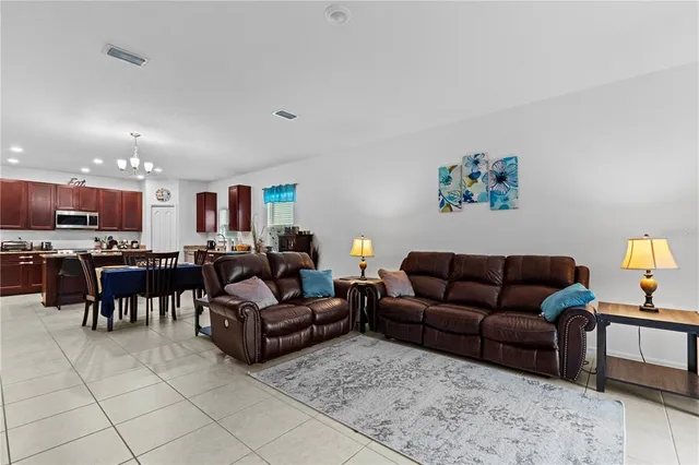 a living room with furniture and kitchen view
