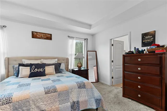 a bedroom with a bed and a dresser