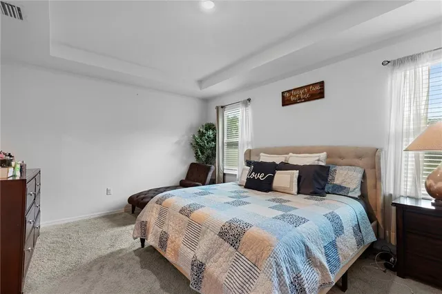 a bedroom with bed and window