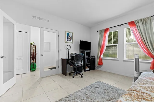 a view of a livingroom with workspace and a window