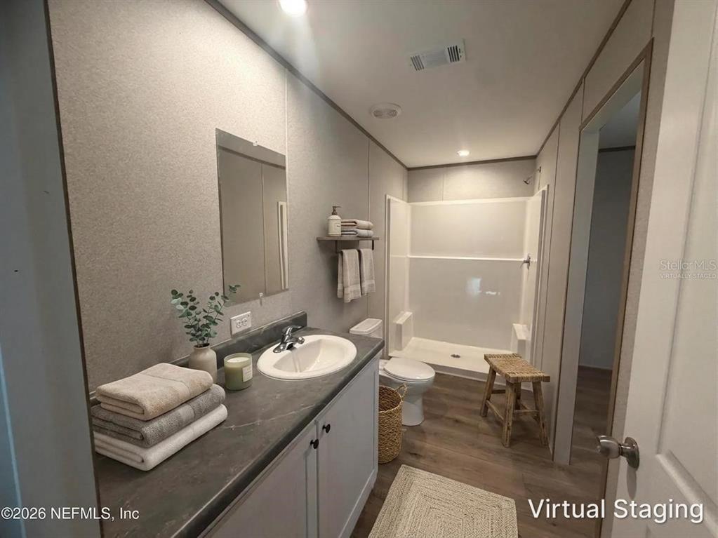 114 Nutmeg Trail Interlachen, FL 32148 - Photo 8 of 33 a bathroom with a sink a toilet and shower