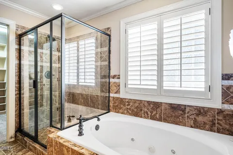 a bathroom with a bathtub and shower