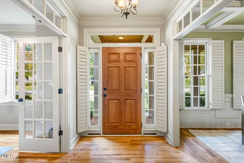 a view of front door of house and wooden floor