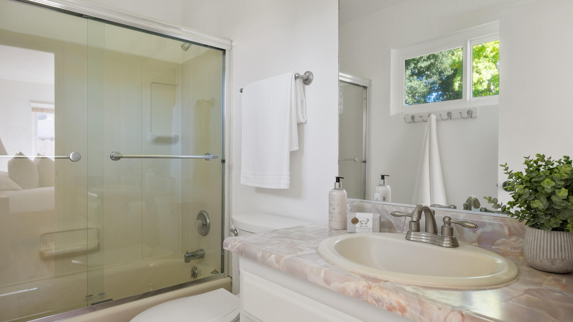 67 Pepperwood Way Solvang, CA 93463 - Photo 11 of 25 a bathroom with a granite countertop shower a sink and a mirror