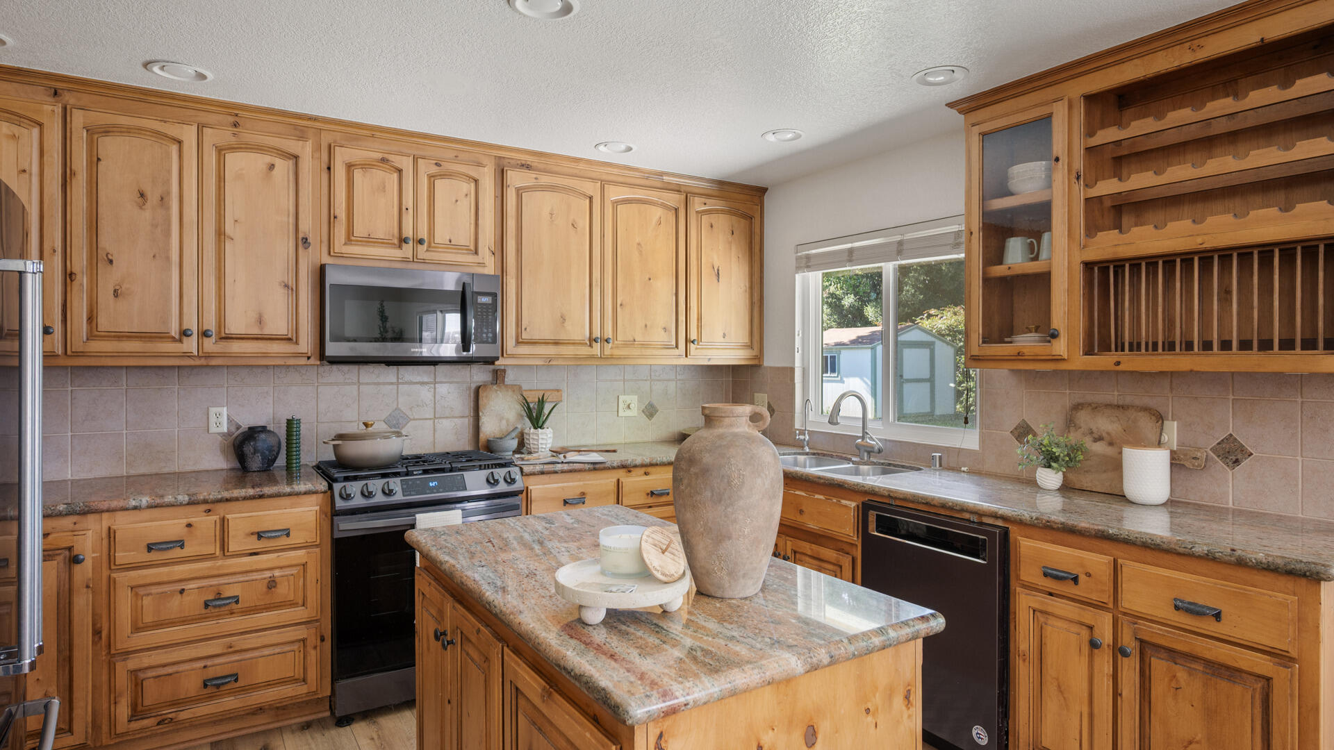 67 Pepperwood Way Solvang, CA 93463 - Photo 6 of 25 a kitchen with stainless steel appliances granite countertop a sink stove and cabinets