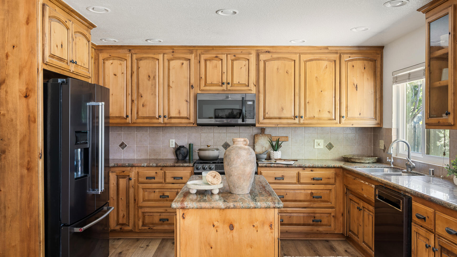 67 Pepperwood Way Solvang, CA 93463 - Photo 7 of 25 a kitchen with stainless steel appliances granite countertop a stove top oven a refrigerator a sink and dishwasher with granite countertops