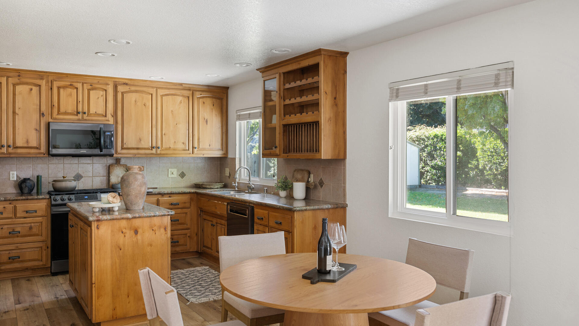67 Pepperwood Way Solvang, CA 93463 - Photo 8 of 25 a kitchen with a stove a sink and a microwave