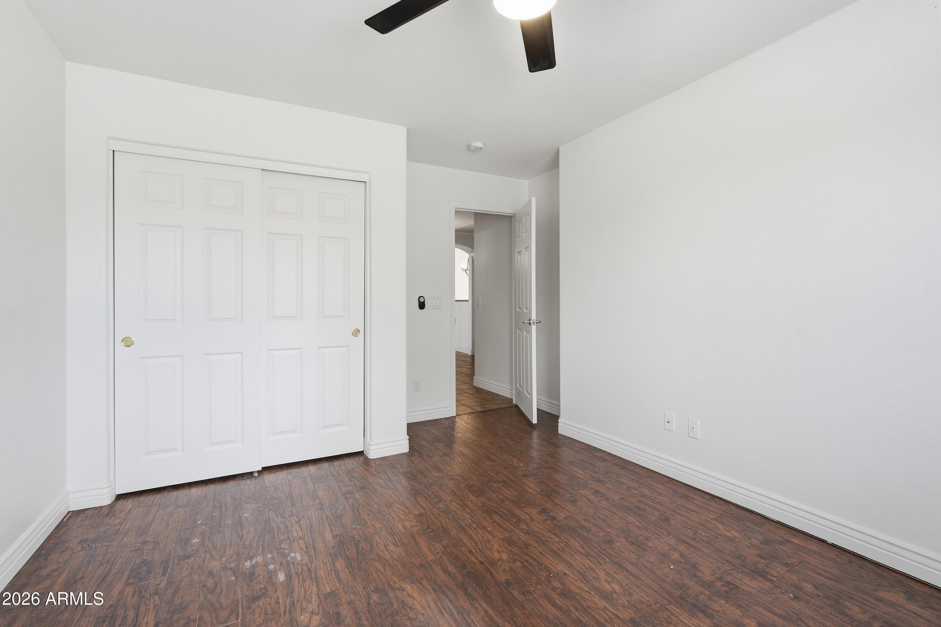 3242 East Bonanza Road Gilbert, AZ 85297 - Photo 22 of 36 an empty room with wooden floor cabinet and windows