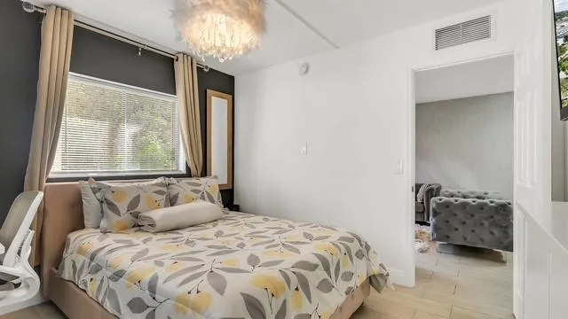 a bedroom with a bed and a window