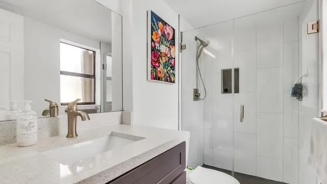 a bathroom with a sink a toilet and a window