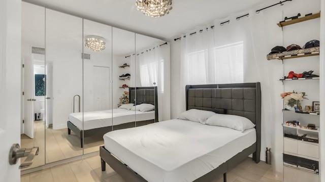 2907 Northeast 8th Terrace, Unit 101 Wilton Manors, FL 33334 - Photo 17 of 24 a bedroom with a bed and a dresser