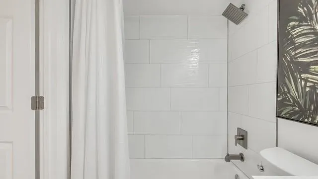 a bathroom with a bathtub and shower