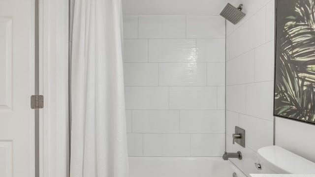 2907 Northeast 8th Terrace, Unit 101 Wilton Manors, FL 33334 - Photo 18 of 24 a bathroom with a bathtub and shower