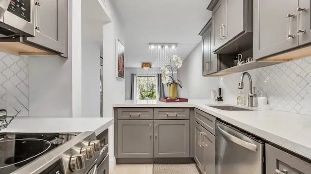 a kitchen with a sink stove top oven and cabinets