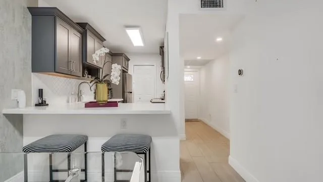 a kitchen with a table and chairs in it