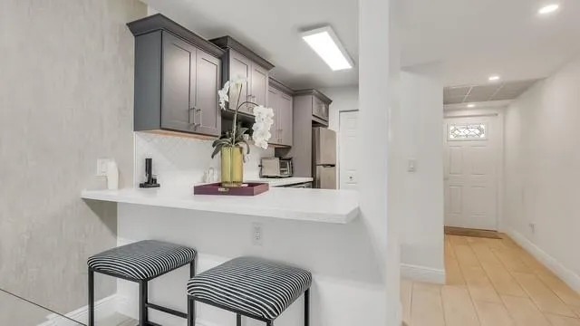 a hallway with a sink and a mirror