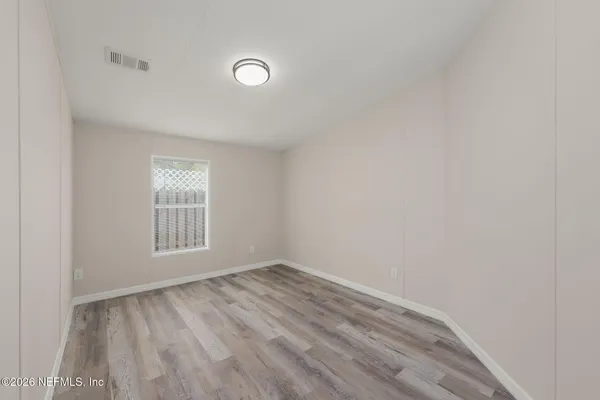 a view of an empty room with a window