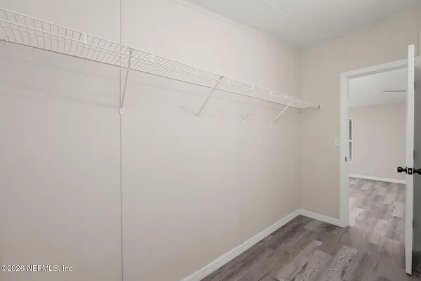 a view of a room with wooden floor