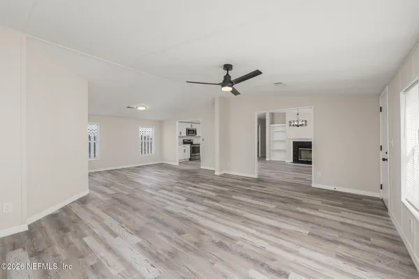 a view of a livingroom with a hardwood floor and a ceiling fan