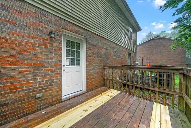 a balcony with wooden floor and fence