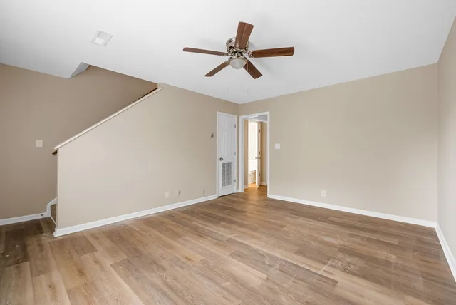 a view of room with wooden floor and ceiling fan