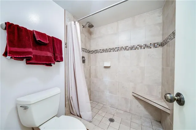 a bathroom with a toilet and a shower