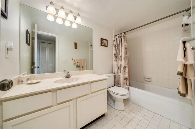 a bathroom with a double vanity sink toilet and shower