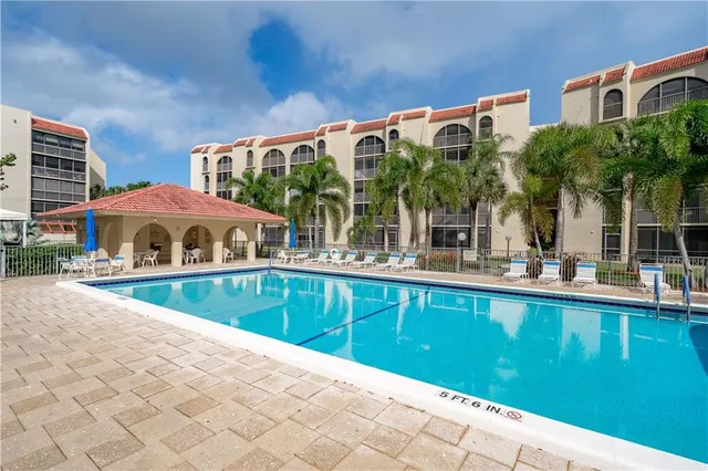 a view of swimming pool with outdoor seating and a patio