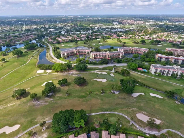 an aerial view of residential houses with outdoor space and swimming pool