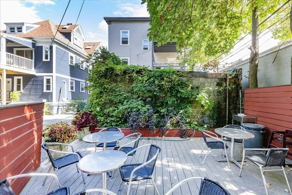 a view of a patio with table and chairs and potted plants