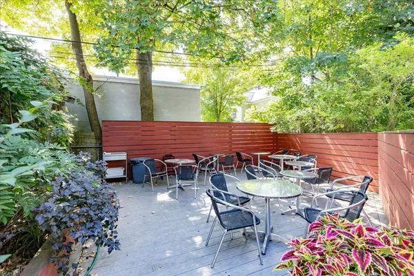 a view of patio with table and chairs and potted plants