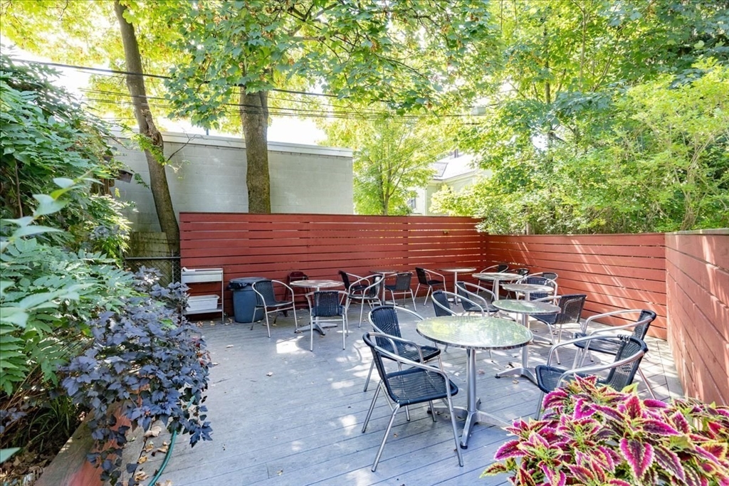 55 South Street, Unit 3 Boston, MA 02130 - Photo 9 of 10 a view of patio with table and chairs and potted plants