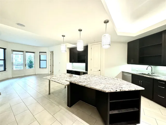 a kitchen with a sink counter top space and living room view