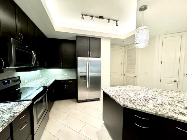 a bathroom with a granite countertop sink toilet a mirror and bathtub