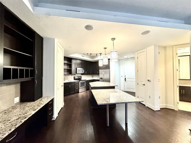 a kitchen with granite countertop counter top space a sink stainless steel appliances and cabinets