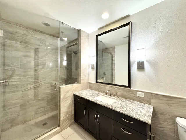 a bathroom with a glass shower door