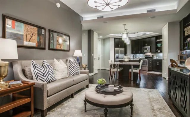 a living room with furniture kitchen and a table