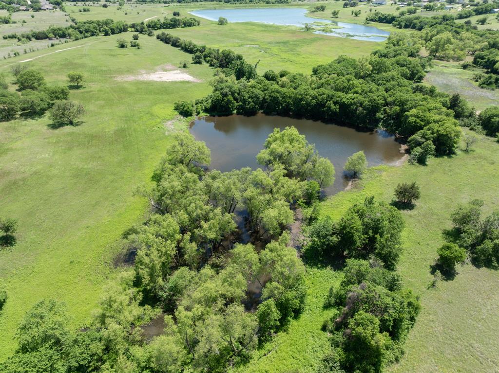 1355 North Houston Street Lorena, TX 76655 - Photo 31 of 40 an aerial view of ocean with residential houses with outdoor space and trees all around