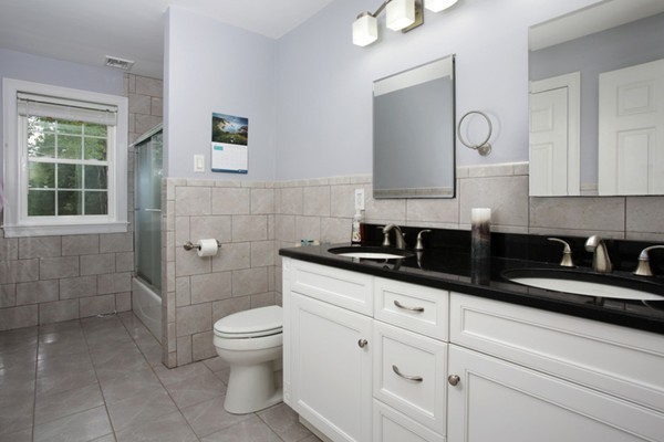 30 Cormier Road Burlington, MA 01803 - Photo 5 of 12 a bathroom with a granite countertop sink a toilet and mirror