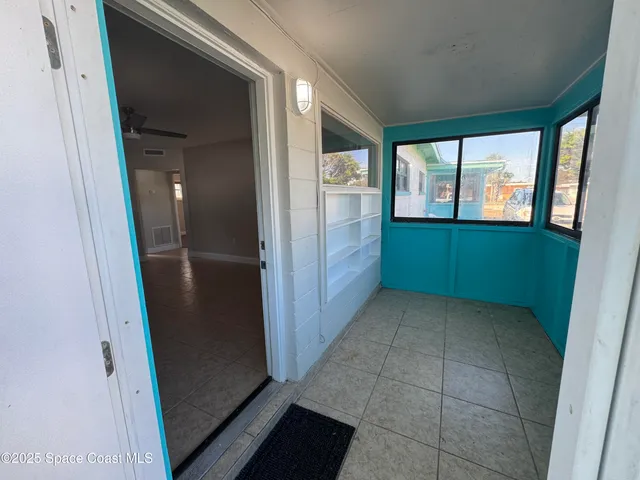 a view of a hallway with a kitchen