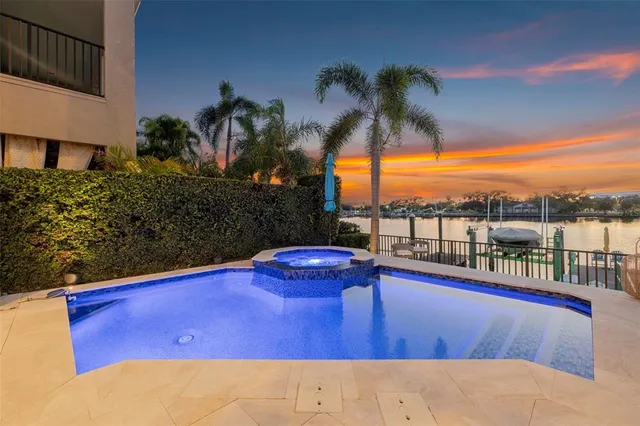 a spacious bedroom with a bed and a flat screen tv