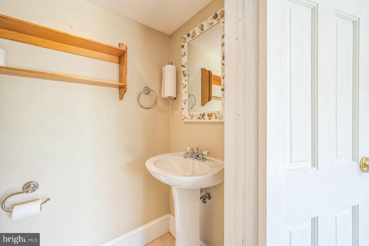 9731 Glenhope Road Philadelphia, PA 19115 - Photo 17 of 36 a bathroom with a sink a mirror and shower