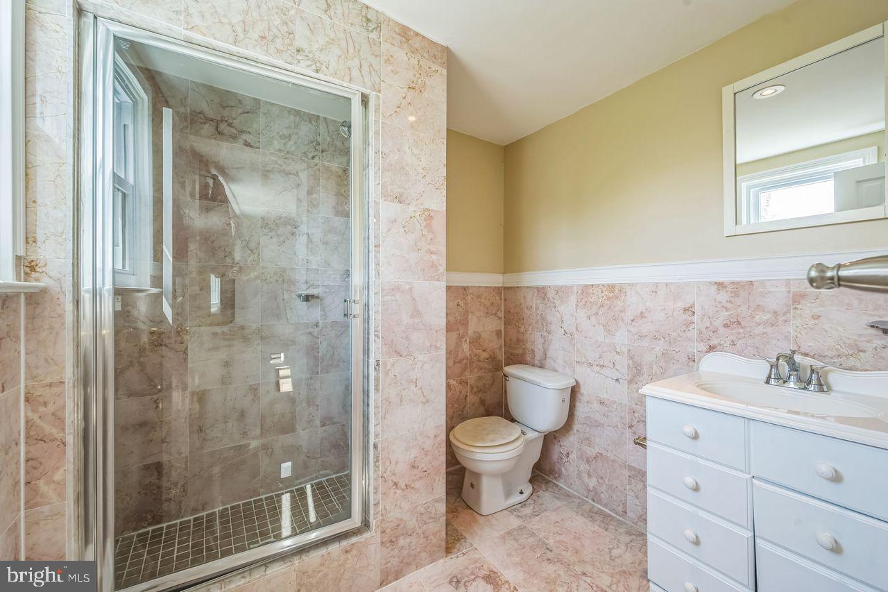 9731 Glenhope Road Philadelphia, PA 19115 - Photo 22 of 36 a bathroom with a toilet a sink and shower