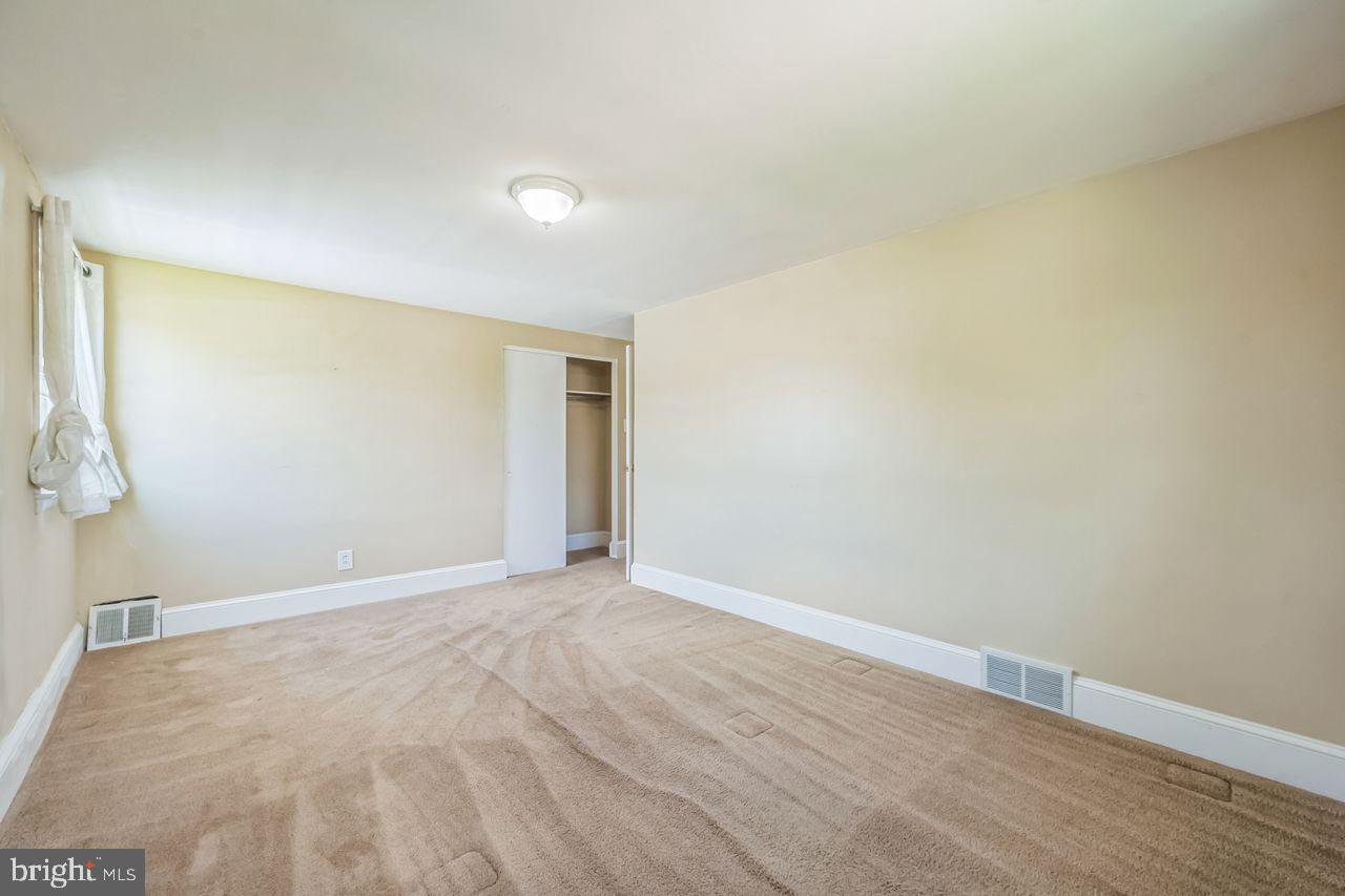 9731 Glenhope Road Philadelphia, PA 19115 - Photo 25 of 36 a view of an empty room with wooden floor and a window