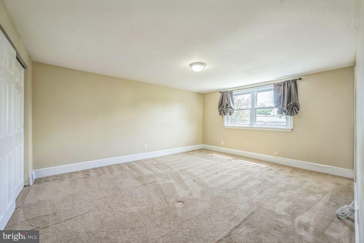 9731 Glenhope Road Philadelphia, PA 19115 - Photo 29 of 36 an empty room with a windows and closet