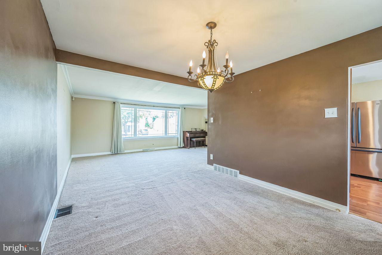 9731 Glenhope Road Philadelphia, PA 19115 - Photo 7 of 36 a view of a big room with windows and chandelier