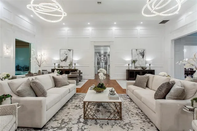 a living room with furniture and a large mirror