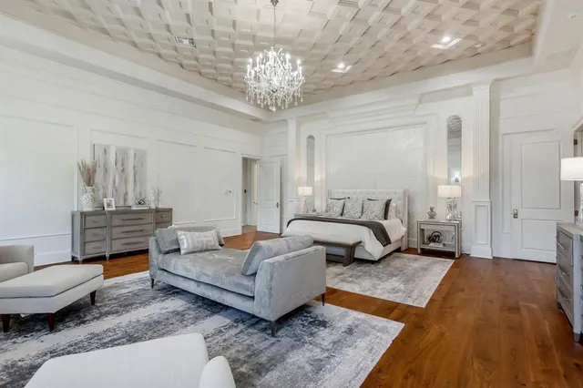 a bedroom with a large bed and a couch