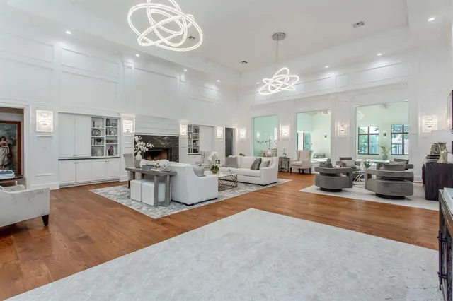 a living room with fireplace furniture and a view of kitchen