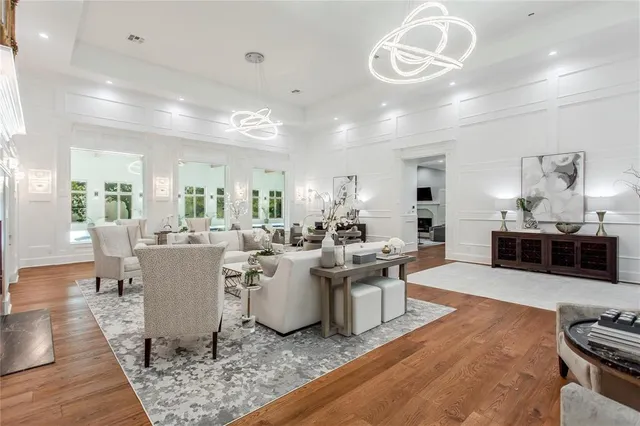 a living room with lots of furniture and kitchen view
